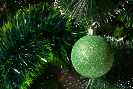 Green Christmas ball hanging on Christmas tree. holiday and new year conceptの写真素材