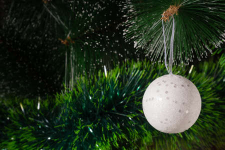 White Christmas ball hanging on Christmas tree. holiday and new year conceptの写真素材