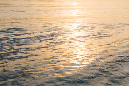 sunlight plays on the river ripple surface. sunset water surface. water background. blue and sunny water surface. abstract blue waterの写真素材