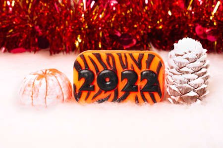 Christmas and New Year decorations, pine cone, mandarin, 2022 on a light background. Handmade New Year soap. Xmas toys. Holiday concept, gifts and homemade soapの写真素材