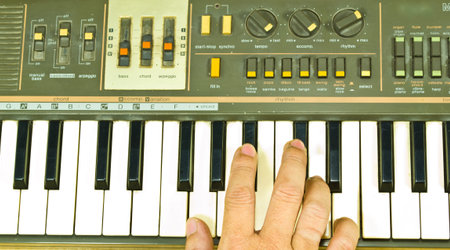 Keyboard by hand on a black background. Is the source of music.