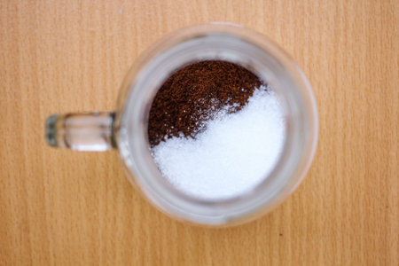 Top view of coffee grounds and sugar in the glassの写真素材