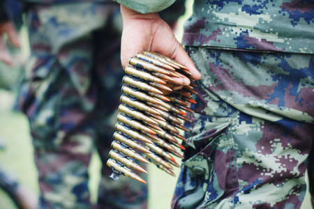 chain of 7 2 mm bullet on handの写真素材