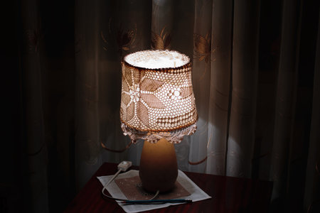 retro vintage lamp light creating cozy atmosphere shining on wooden table in living room on dark...