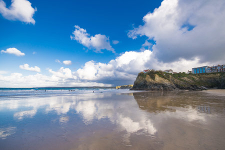A view of Tolcarne Beach in Newquay,Cornwall, UK. Surfers in the ripples during winter. 