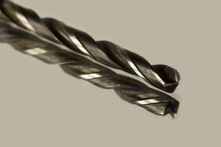 Drill with reflection on a glass surface.