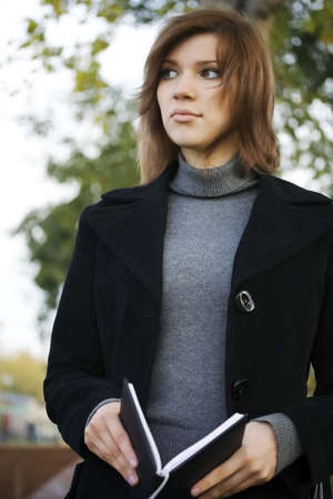 Beautiful girl holding a book.の写真素材