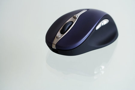 Wireless computer mouse on a glass.
