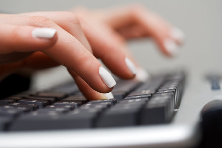 Female hands typing on keyboard.