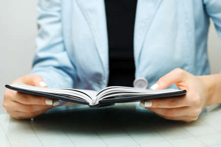 Businesswoman reading the accounting ledger.の写真素材