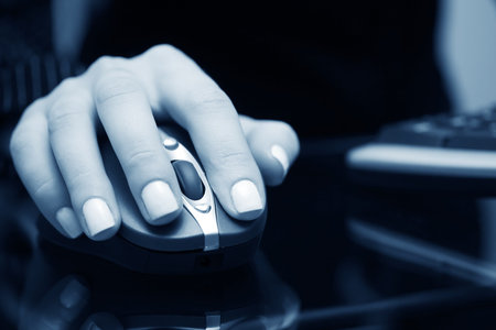 Female hand holding the computer mouse.