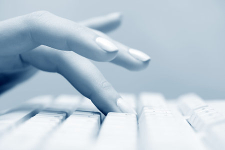 Female hand typing on keyboard.