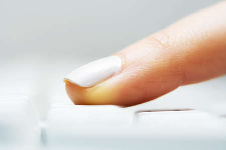 Female finger typing on keyboard.の写真素材