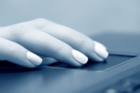 Female hand using touchpad.
