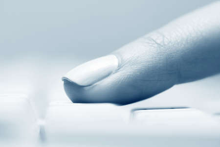 Female finger typing on keyboard.の写真素材