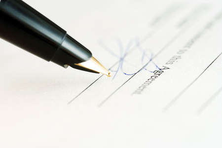 Fountain pen and signing the document.の写真素材