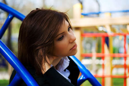 Young woman feel nostalgic for childhood in the playground.の写真素材