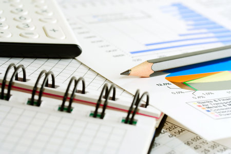 Calculator, pencil and stock index reports.