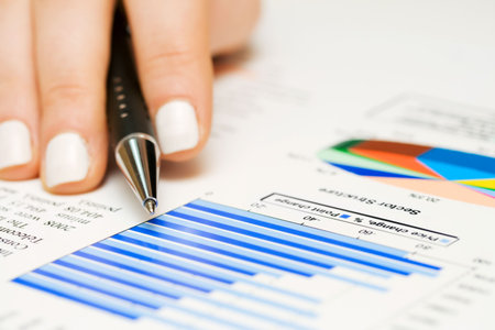 Female hand and monitoring of stock index.
