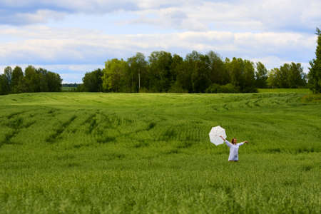 Happy young woman walking on nature.の写真素材