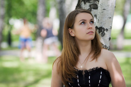 Thoughtful young woman looking away.