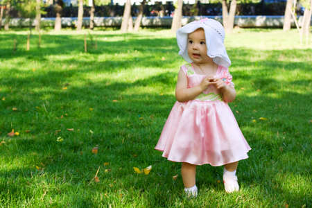 Little baby walking in the city park.の写真素材