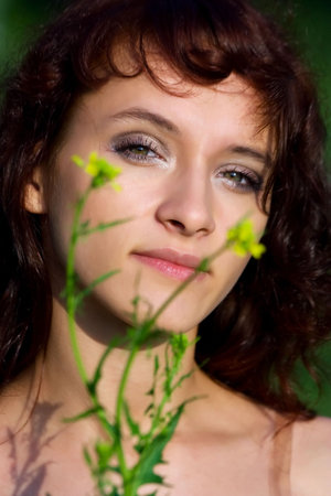 Beautiful young woman and wild flowers.