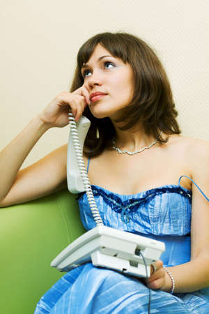 Thoughtful woman on the phone.の写真素材