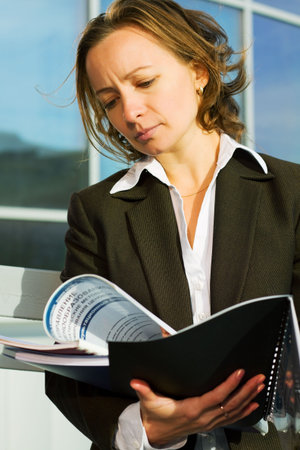 Young businesswoman reading a financial reports.
