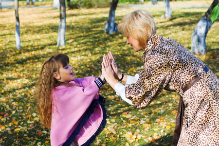 Mother and daughter playing in the park.の写真素材