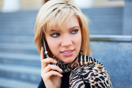 Young blonde woman on the phone.の写真素材