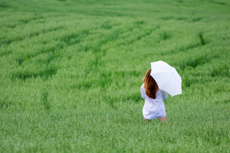 Young woman walking in a field.の写真素材