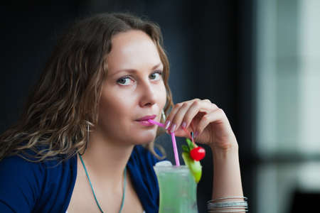 Beautiful woman with a cocktail.の写真素材