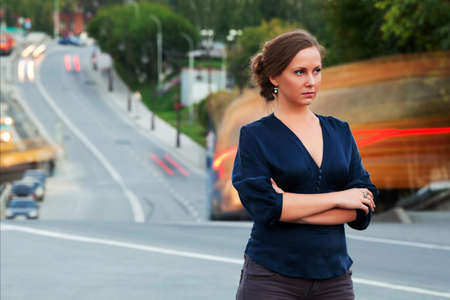 Young woman against city traffic.の写真素材