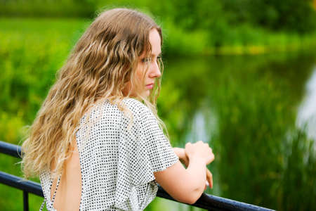 Beautiful woman by the lake.の写真素材