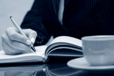 Businesswoman writing.の写真素材