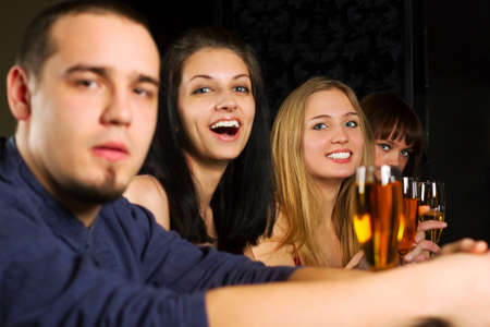 Young people relaxing in a night bar.の写真素材