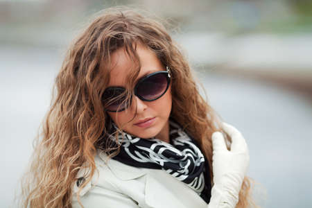 Sad young woman on the city street.の写真素材