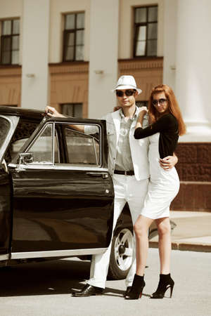 Young couple with a retro car.の写真素材
