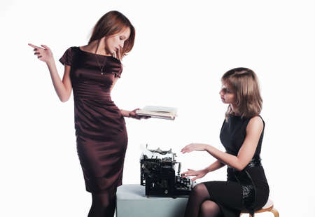 Two young retro secretaries with a typewriterの写真素材