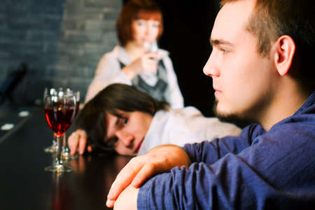 Young men relaxing on a bar counterの写真素材
