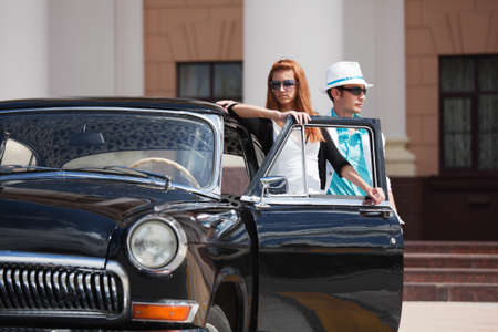 Young couple with a retro car の写真素材