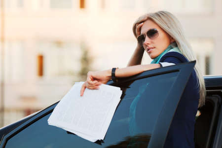 Young businesswoman with financial reportsの写真素材