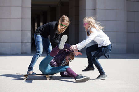 Teens playing with skateboardの写真素材