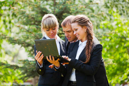 Young business people with laptopの写真素材