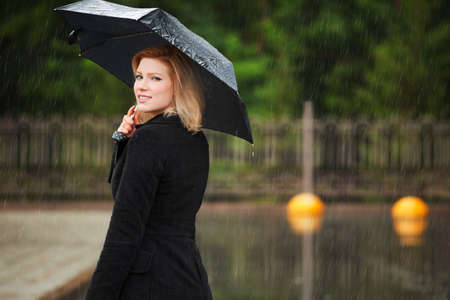 Woman with umbrella in the rainの写真素材