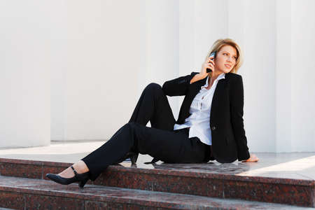 Young businesswoman calling on the phoneの写真素材