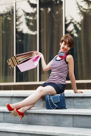 Happy shopper on the stepsの写真素材