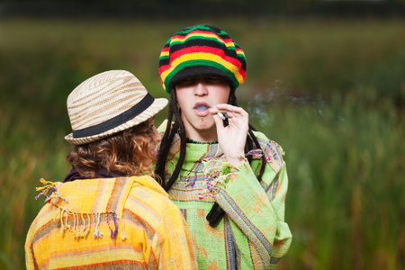 Young rastafarian people in autumn park