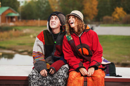 Young hippie couple in autumn parkの写真素材